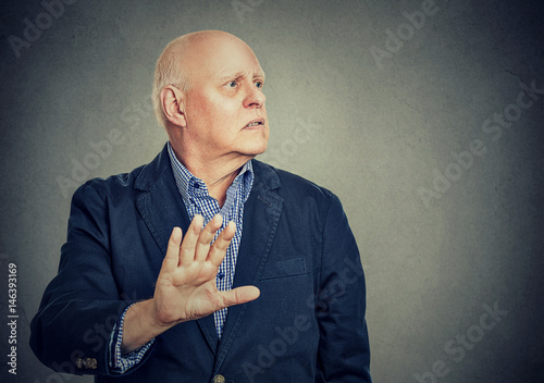 Upset annoyed man giving talk to my hand gesture