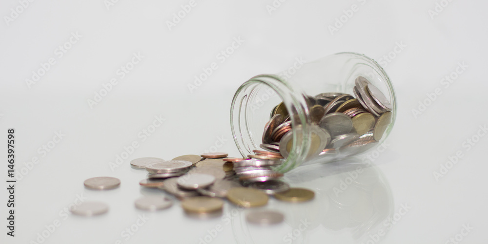 Glass jar saving money with coin on white background. Glass jar saving money with coin on white background.