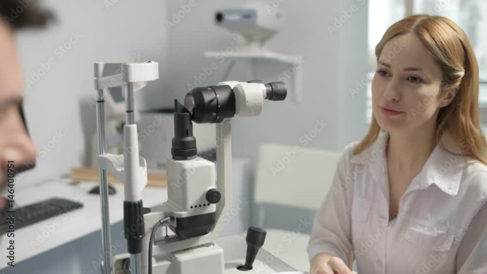 Cheerful ophthalmologist consulting patient Cheerful ophthalmologist consulting patient