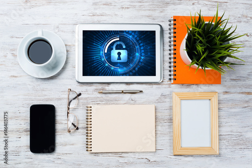 Web security and technology concept with tablet pc on wooden table