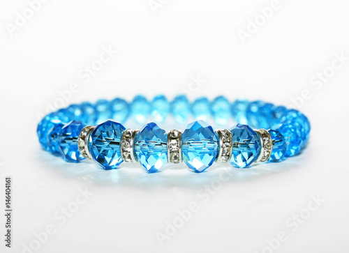 Blue bracelet isolated on white with special lightning
