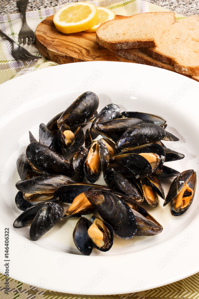 mussels with garlic and butter sauce in a deep plate mussels with garlic and butter sauce in a deep plate