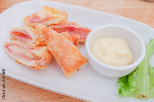 " Deep fried spring roll with ham cheese " serve on dish with salad sauce , Thailand.