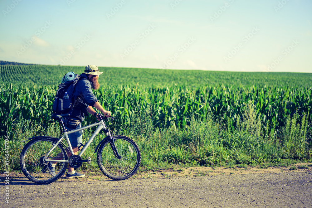 Fototapeta premium hipster man on a bicycle in the countryside