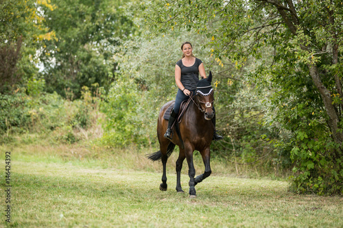Young Woman Riding Her Horse © nullplus