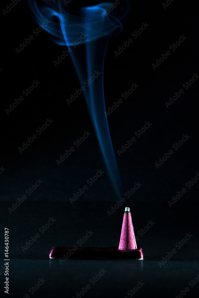 Fumming incense stick on black background