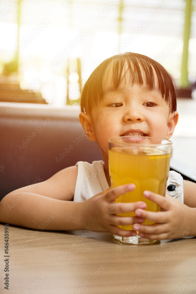 Asian little Chinese girl drinking lemon tea Asian little Chinese girl drinking lemon tea