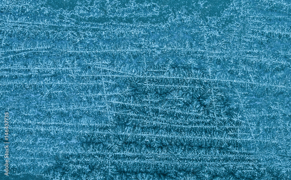 Frozen snowy surface in blue