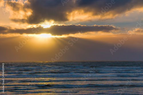 Sun rays behind approaching storm over Pacific Ocean off Olympic Peninsula.  