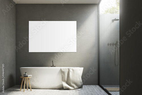 Gray bathroom with a tub and poster