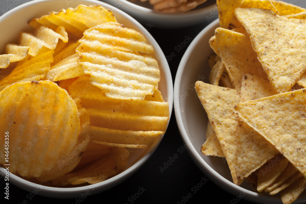 Potato chips in bowl on a table Potato chips in bowl on a table