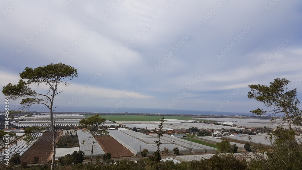 Agriculture farming greenhouses and Mediterranean Sea panoramic landscape, view from Carmel mountains, Israel Agriculture farming greenhouses and Mediterranean Sea panoramic landscape, view from Carmel mountains, Israel