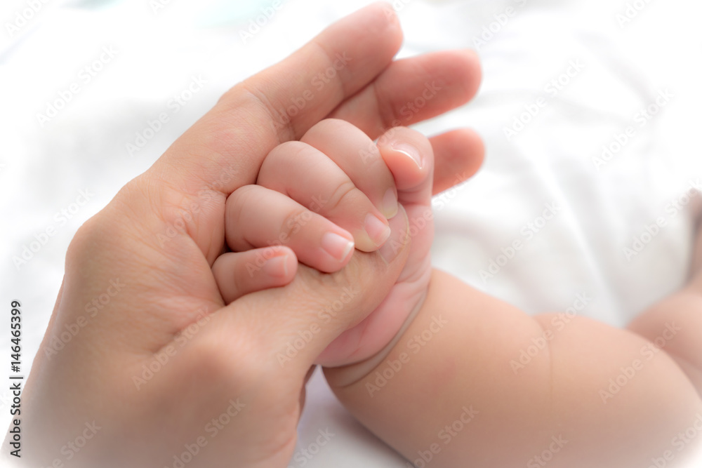 close-up hand of baby in the hand of mother. close-up hand of baby in the hand of mother.