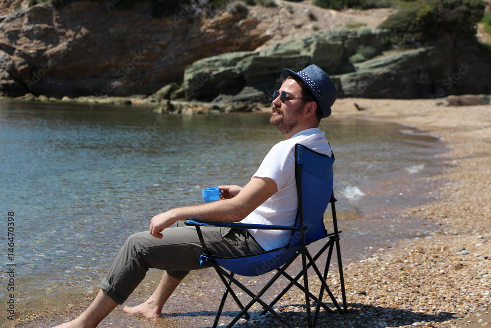 Fototapeta premium a man sitting on the beach