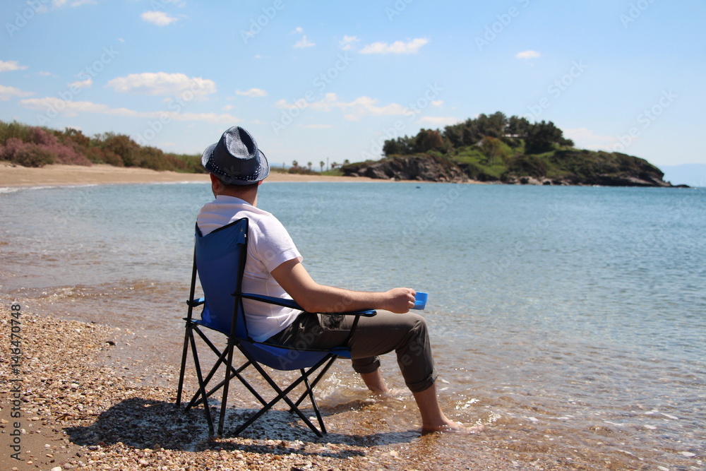 a man sitting on the beach