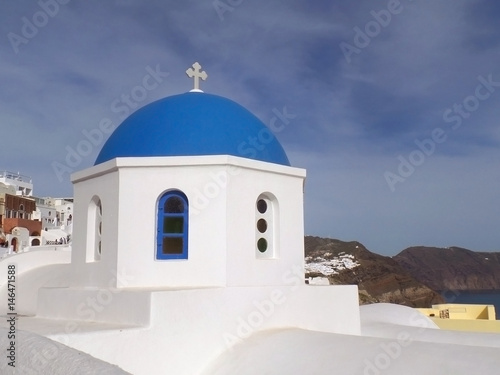The unique pure white and vivid blue Greek islands style church at Oia village on Santorini island, Greece 