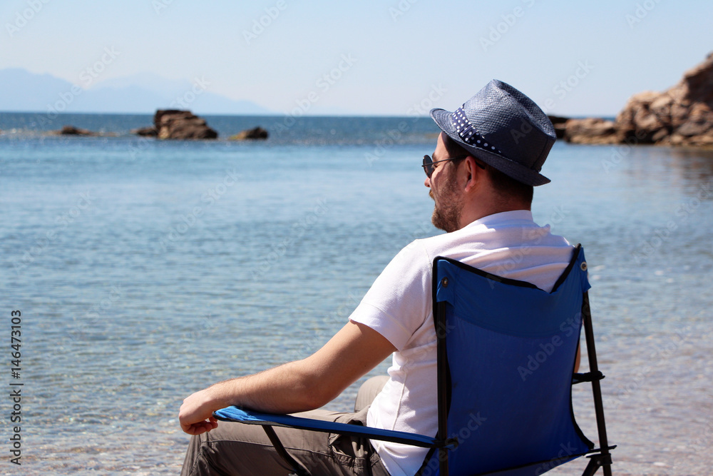 Fototapeta premium a man sitting on the beach