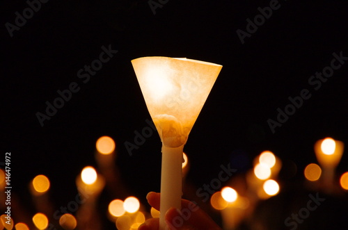 candlelight vigil with shallow depth of field creating round bokeh