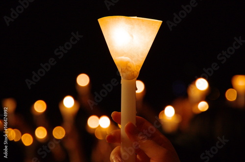 candlelight vigil with shallow depth of field creating round bokeh photo