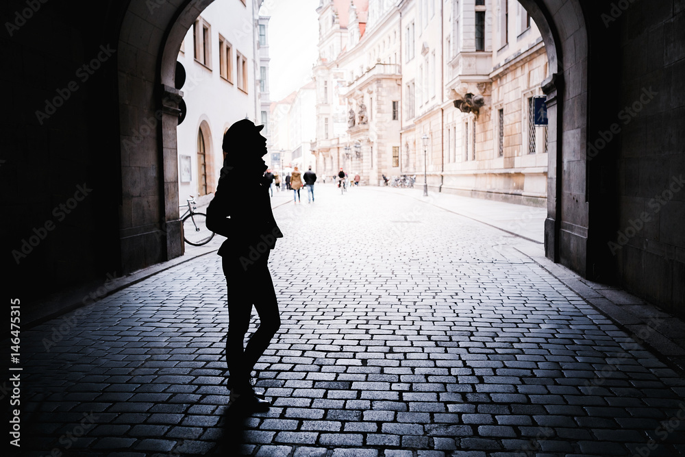 woman silhouette in the arch with paving stones in Europe