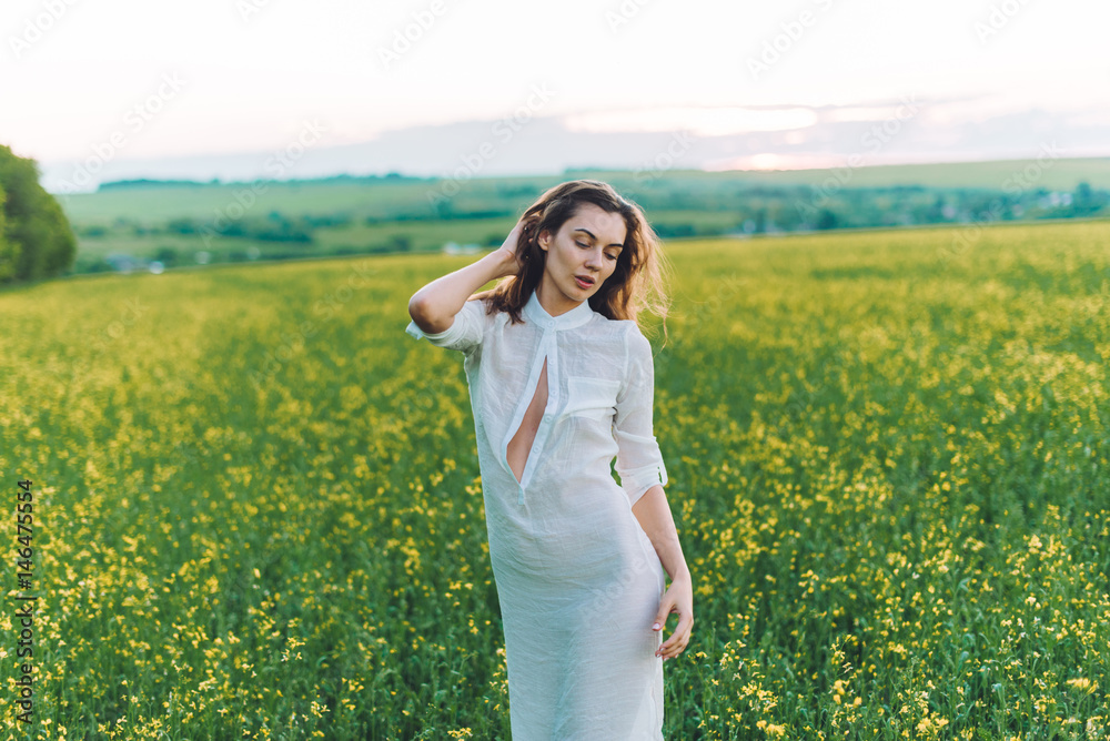 Girl walking in the field at sunset Girl walking in the field at sunset