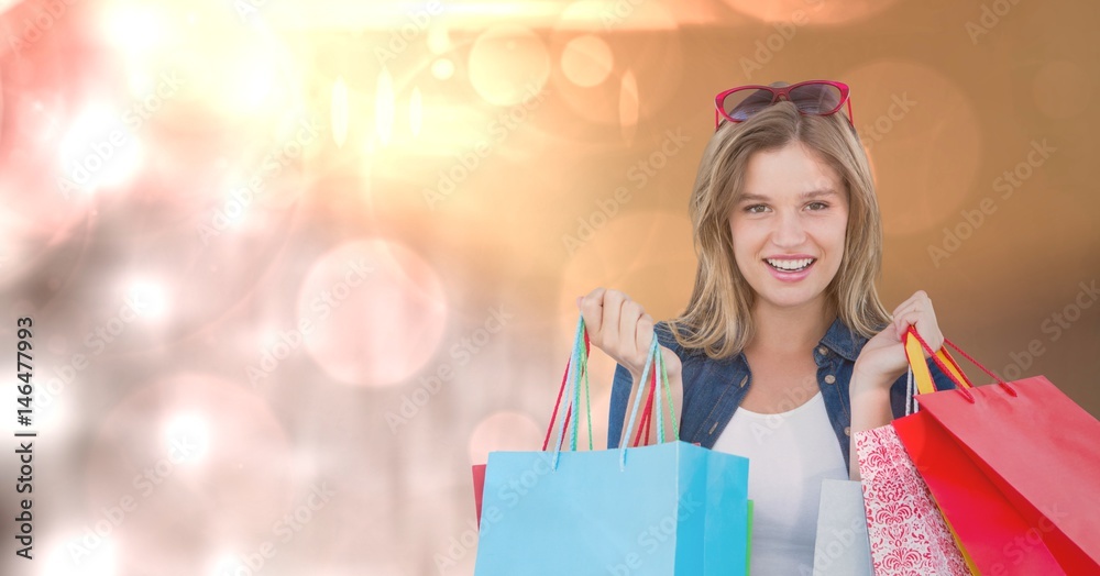 Portrait of woman with carrying shopping bags over bokeh Portrait of woman with carrying shopping bags over bokeh