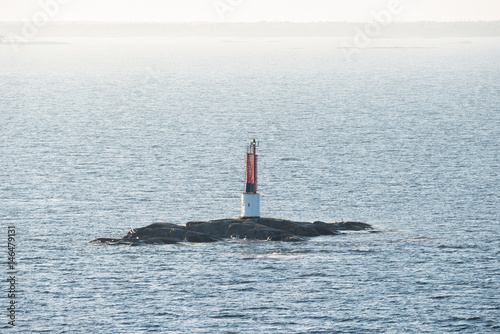 Tableau sur toile Red beacon on a small rock at a seaway