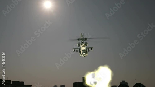 Military helicopter shoots missiles with explosion photo