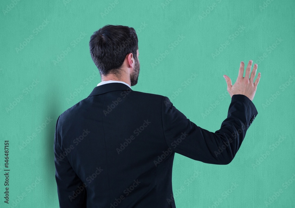 Rear view of businessman gesturing over green background Rear view of businessman gesturing over green background