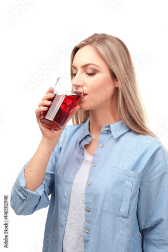 Beautiful young woman drink...