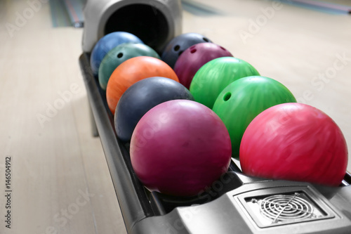 Colorful balls on rack in bowling club