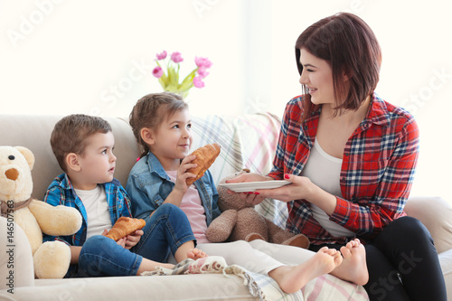 Mother giving children tast...