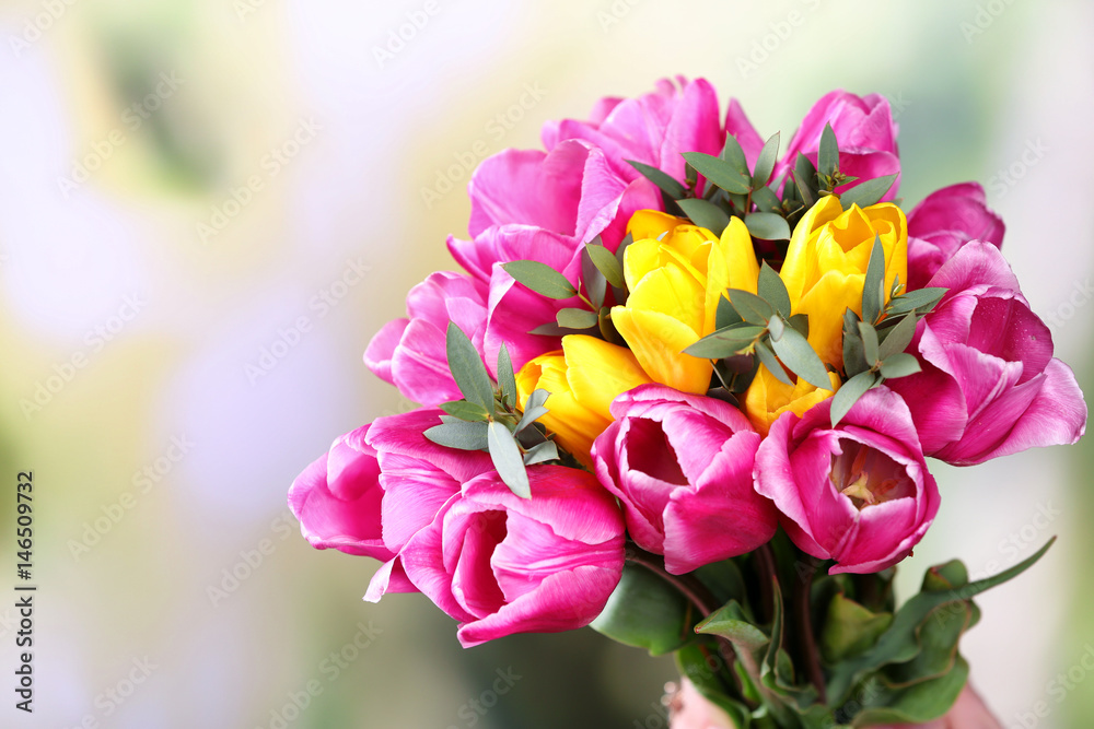 Beautiful bouquet of spring flowers on blurred background