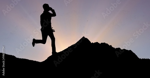 Silhouette businessman using phone and running