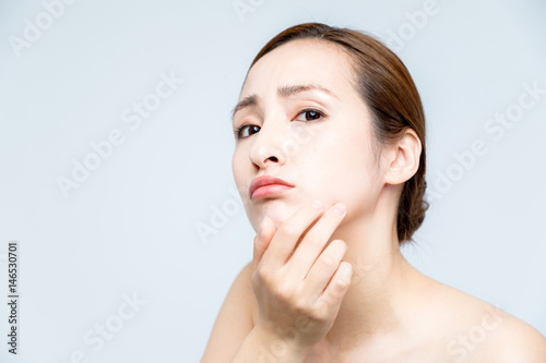 beauty girl who checks her skin, skin care, acne treatment