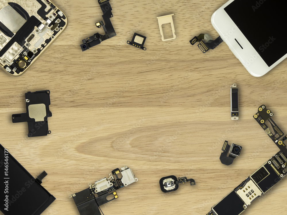 Flat Lay (Top view) of smart phone components on wooden background with copy space Flat Lay (Top view) of smart phone components on wooden background with copy space