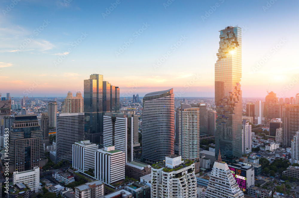 Naklejka premium View of Bangkok modern office buildings, condominium in Bangkok city downtown with sunset sky ,Bangkok is the most populated city in Southeast Asia. Bangkok , Thailand