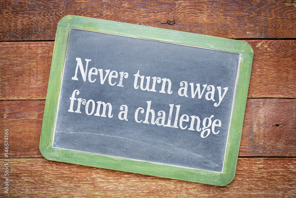 Fototapeta premium Never turn away from a challenge blackboard sign
