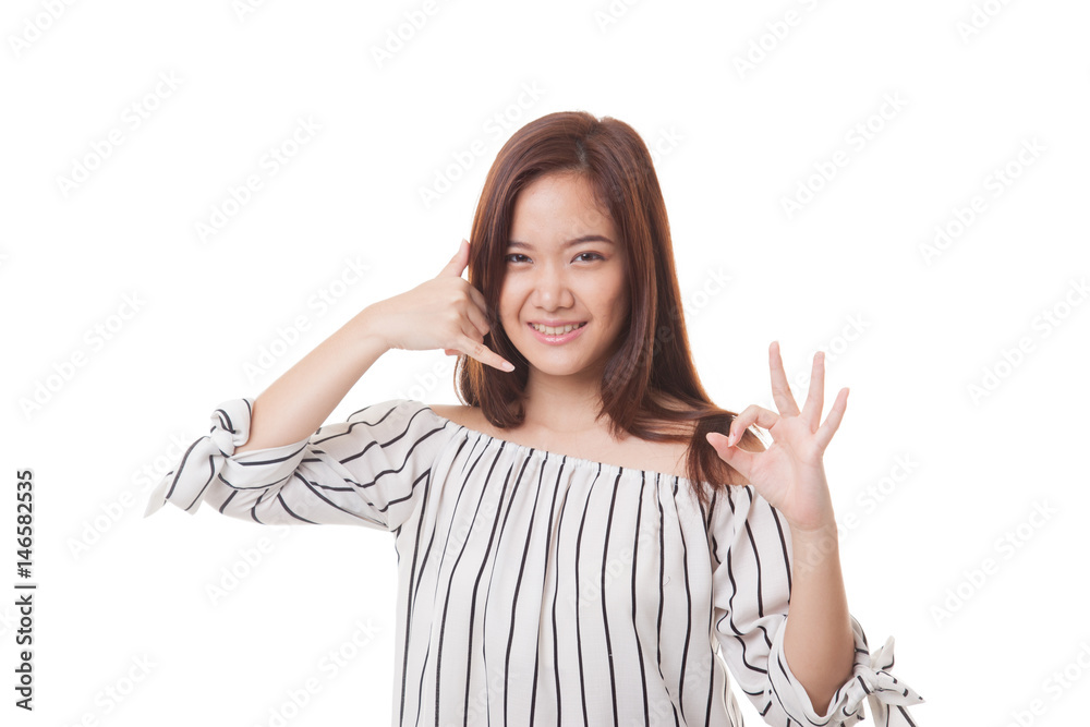 Young Asian woman show with phone gesture and OK sign. Young Asian woman show with phone gesture and OK sign.
