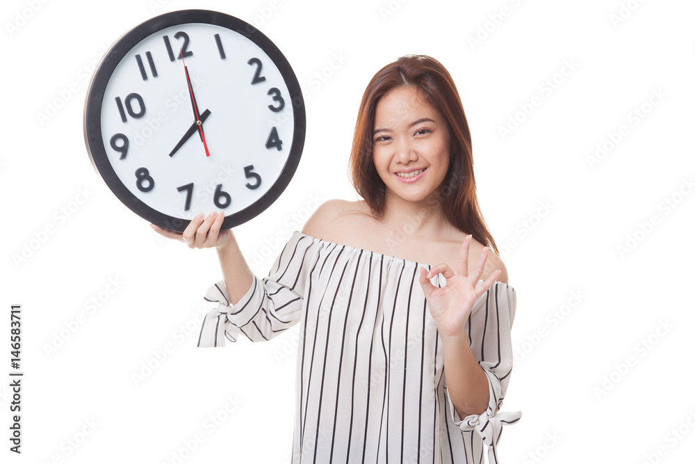 Young Asian woman show OK with a clock. Young Asian woman show OK with a clock.