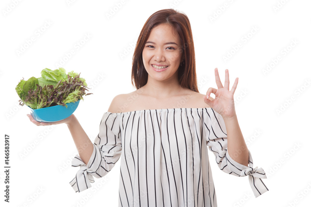 Healthy Asian woman show OK with salad.