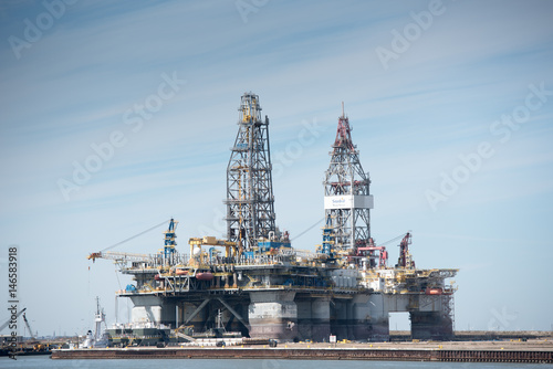 Obraz na plátně Port Aransas, Texas - January 29, 2017 - Two oil exploration platforms are dry docked and being worked on for the oil industry in the Gulf of Mexico