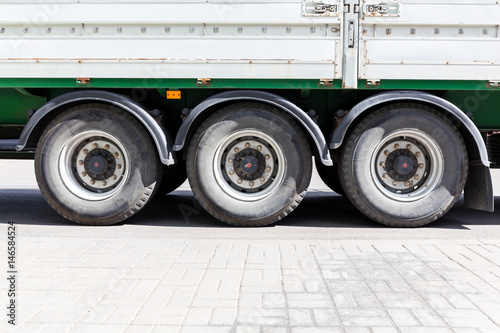 wheels of large truck and trailers at parking lot