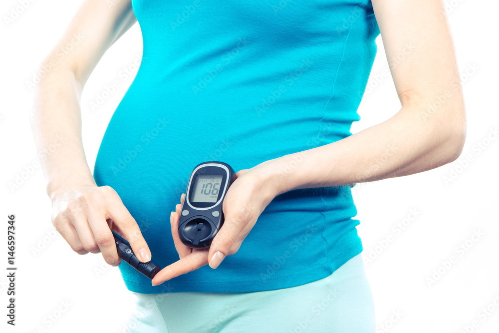 Pregnant woman with glucometer checking sugar level, diabetes during pregnancy Pregnant woman with glucometer checking sugar level, diabetes during pregnancy