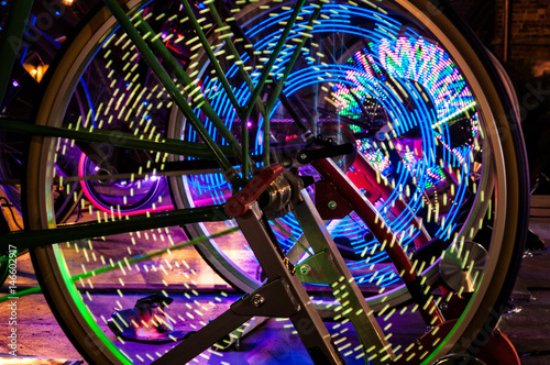 Abstract play of light with lights in bicycle wheel spokes.