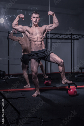 bodybuilder posing, arms outstretched
