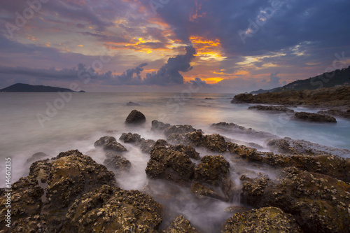 Seascape with rock in beautiful sunset scenery background,long exposure style.