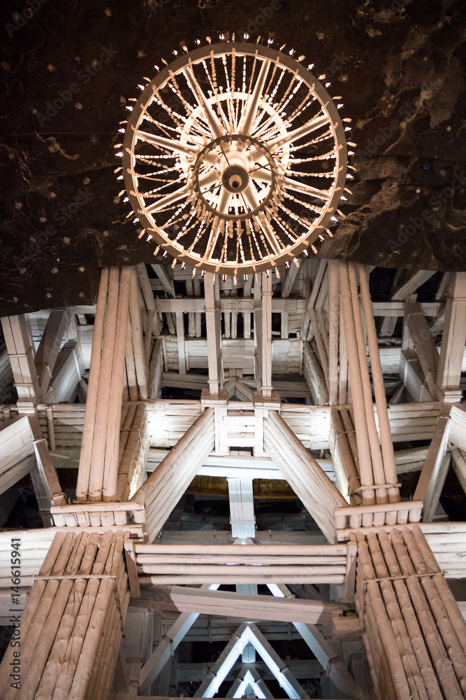 Wieliczka, Poland - 20th October 2016. One of the huge underground vaults in Wieliczka salt mines with a chandelier made out of carved quartz hanging from the ceiling. Wieliczka, Poland - 20th October 2016. One of the huge underground vaults in Wieliczka salt mines with a chandelier made out of carved quartz hanging from the ceiling.