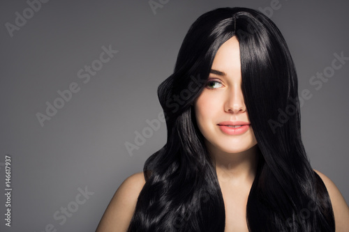 Portrait Of Beautiful Young Brunette Woman With Long Wavy Hair.