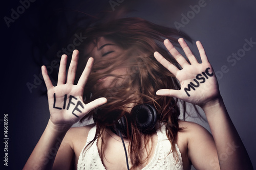 Girl with words life and music on hands 